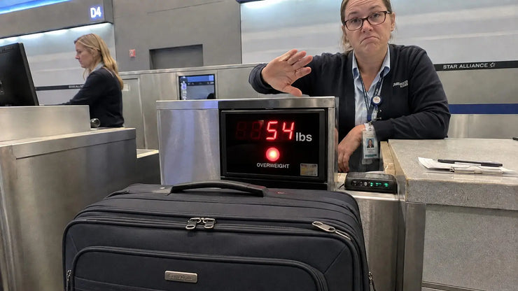 Overweight luggage at airport check-in counter